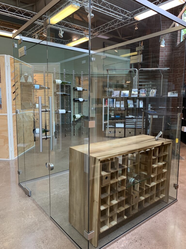 a wine room display in the DT Glass showroom with all four walls made entirely out of glass