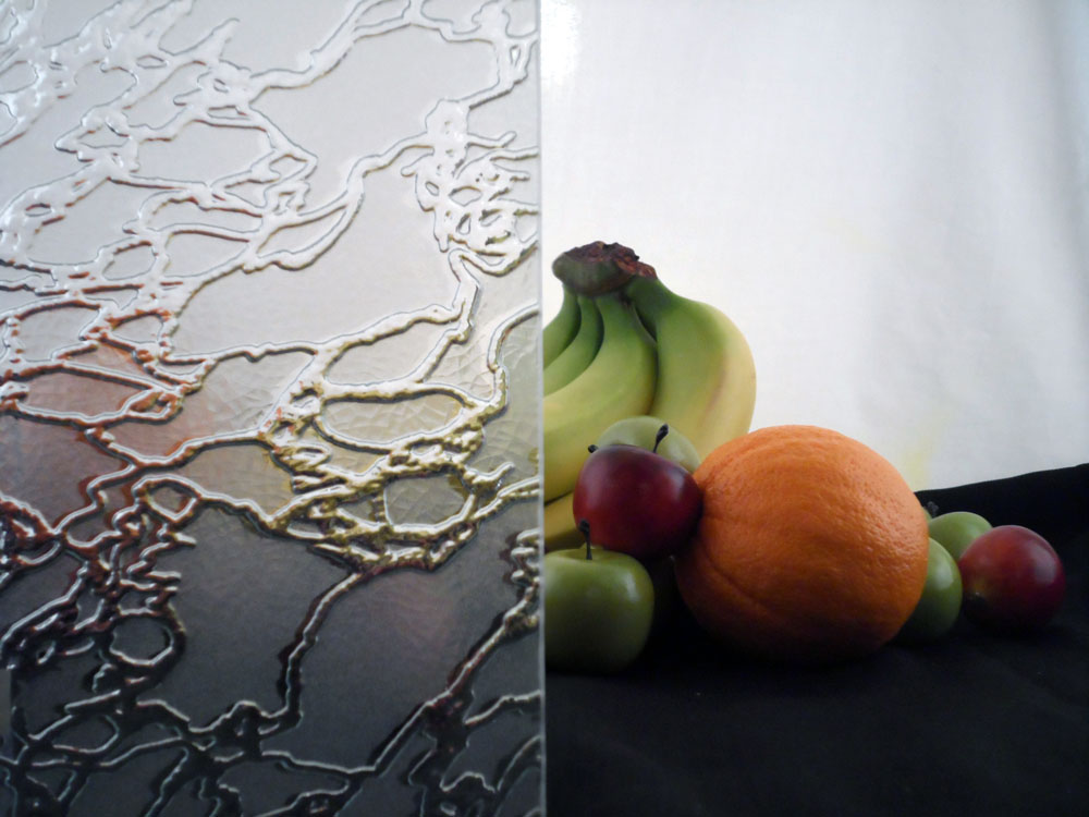 a glass display with some fruit half covered by glass, the glass has a more organic cracked ice pattern with a satin etch everywhere except where the cracks are, the fruit is mostly obscured