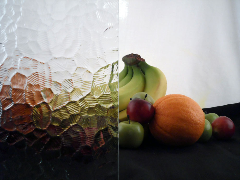 a glass display with some fruit half covered by glass, the glass has a cracked ice pattern