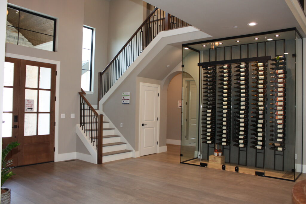 a large wine room tucked underneath a grand staircase