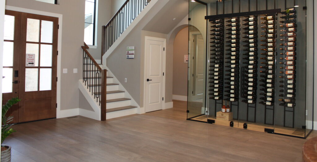 a large wine room tucked underneath a grand staircase