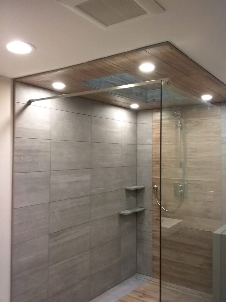 a shower with one panel connected to a wall on the right and the floor, held in place by a support bar keeping the top left corner steady