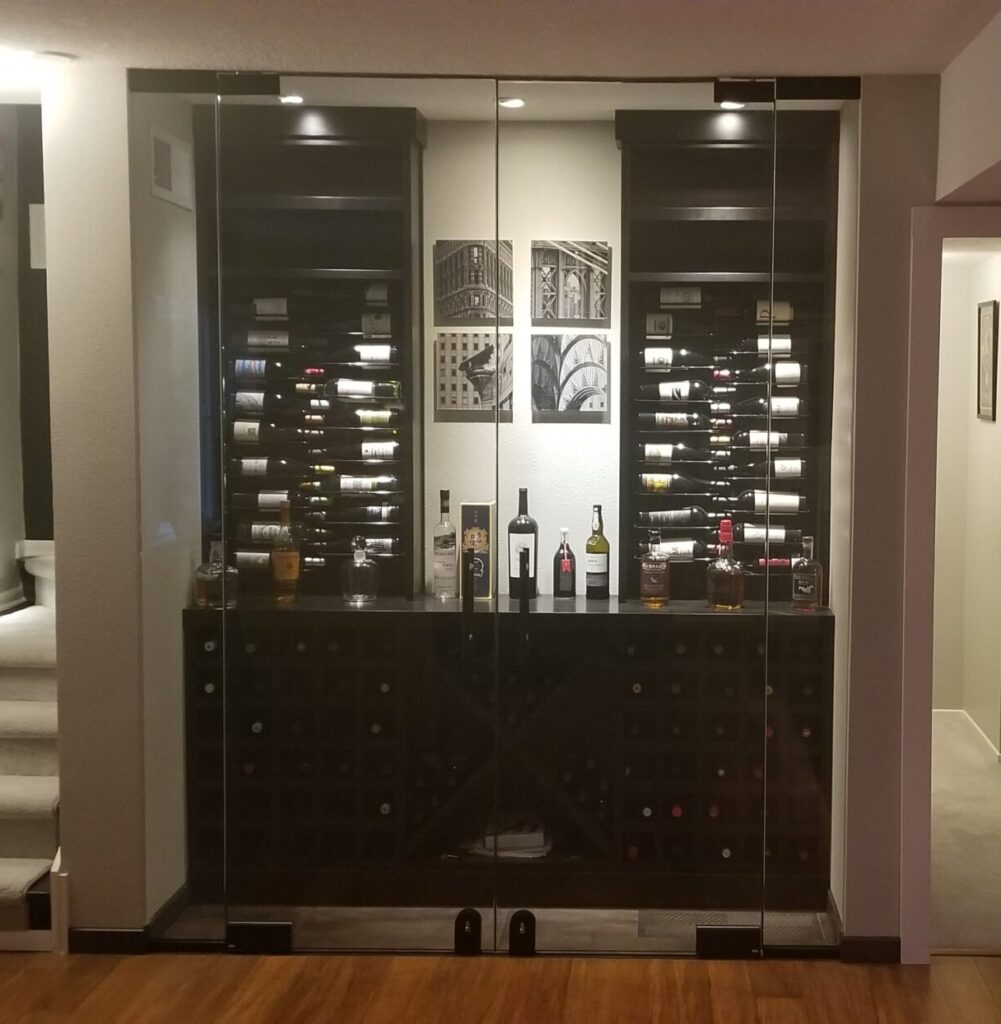 a combination wine room and serving area built into an alcove with double doors